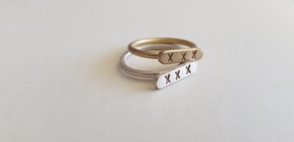 Brass and Silver Kiss signet rings as stack rings