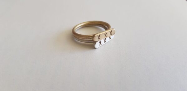 Brass and Silver Kiss signet rings as stack rings