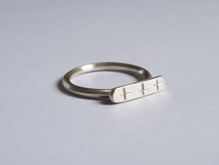 Close-up of silver crisscross signet ring