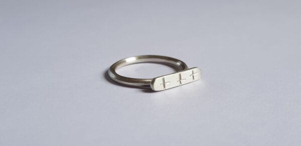 Close-up of silver crisscross signet ring