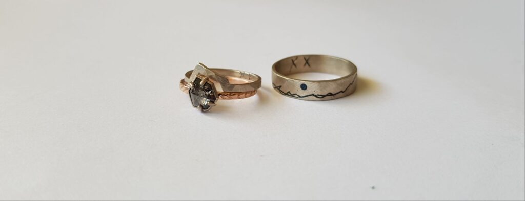 His and hers wedding rings with mountain and river detail