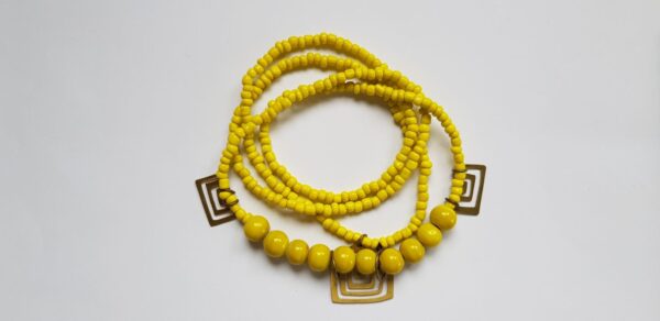 Yellow glass bead necklace with brass handmade brass cutouts