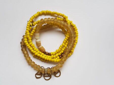 Yellow glass bead necklace with brass cutouts