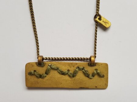 Rectangular brass pendant with khaki cotton mountain ridgeline detail on brass chain