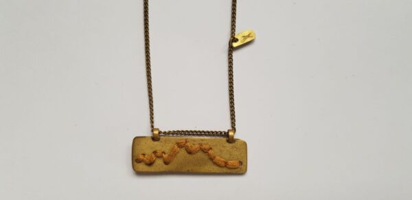 Rectangular brass pendant with Mustard cotton mountain ridgeline detail on brass chain