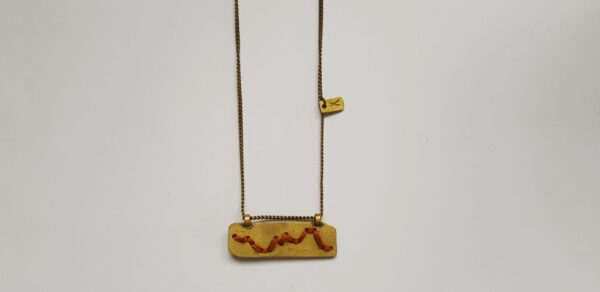 Rectangular brass pendant with Rust colour cotton mountain ridgeline detail on brass chain