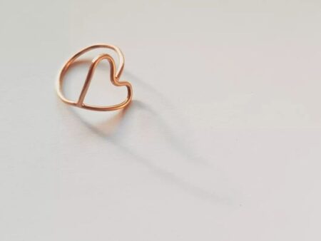 Round wire brass ring full heart in beautiful light casting a shadow