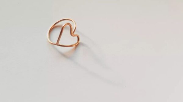 Round wire brass ring full heart in beautiful light casting a shadow
