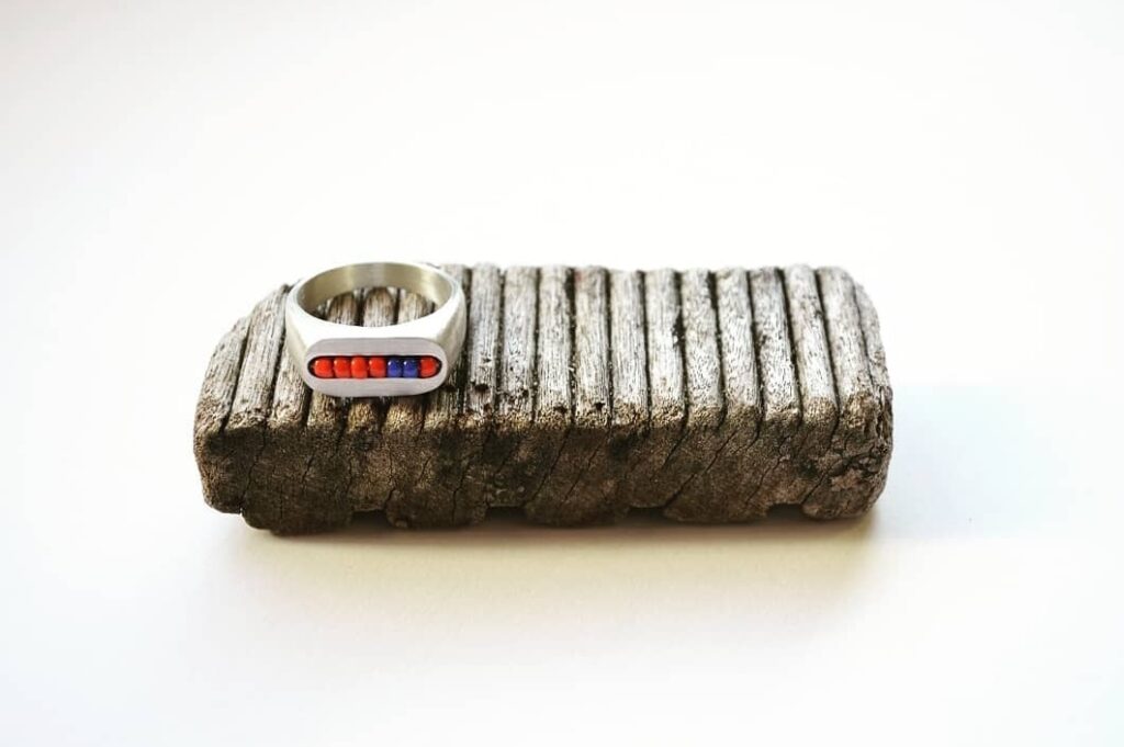 Masaai Mara inspired ring on wooden block for aesthetics