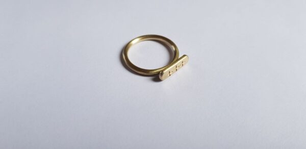 Top view of brass crisscross signet ring