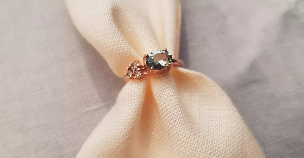 Rose Gold engagement ring with Touramline and a trio of diamonds