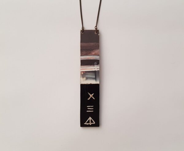 Mixed medium pendant with symbols for detail