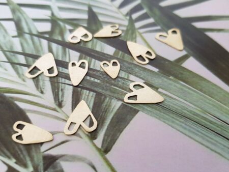 handmade brass heart cutout pendants on palm tree print one